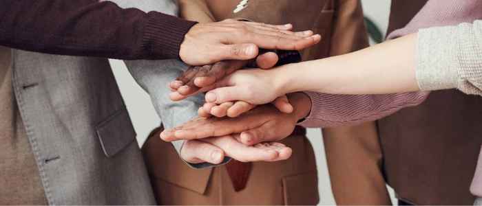 Group of hands together representing a social bond
